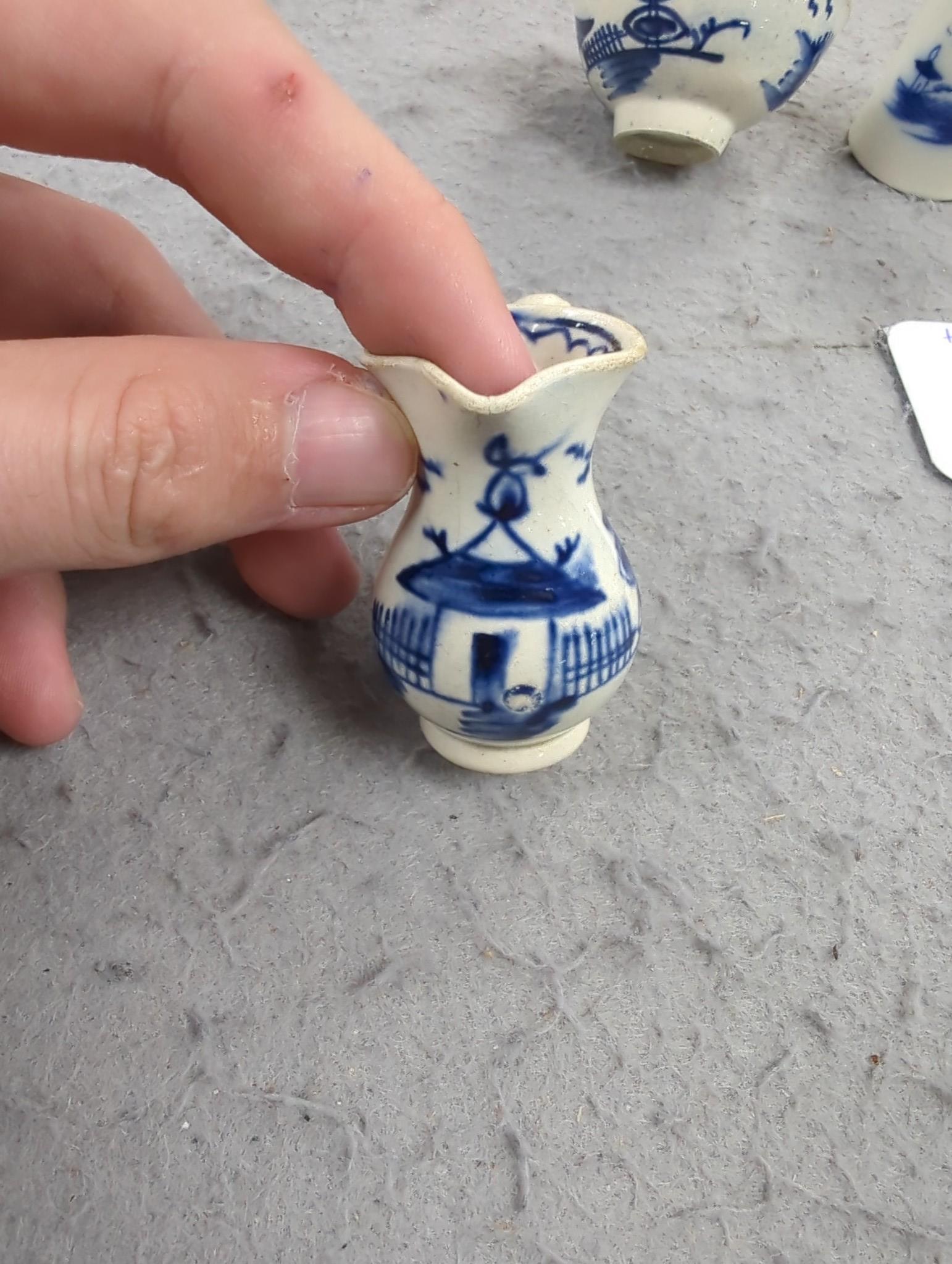 A late 18th century pearlware blue and white miniature jug, 5cm, and tea bowl and an English porcelain miniature mug, late 18th century